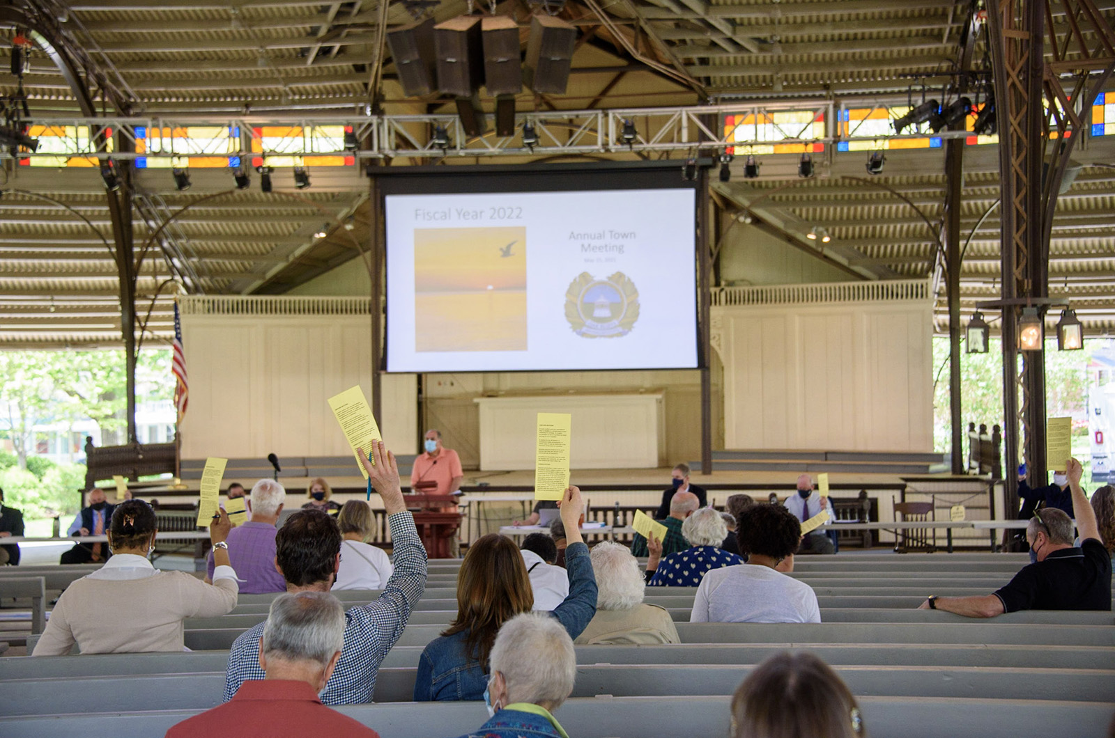 Voters raise their cards at the 2021 Oak Bluffs town meeting, the year the plastic bottle ban passed in town.