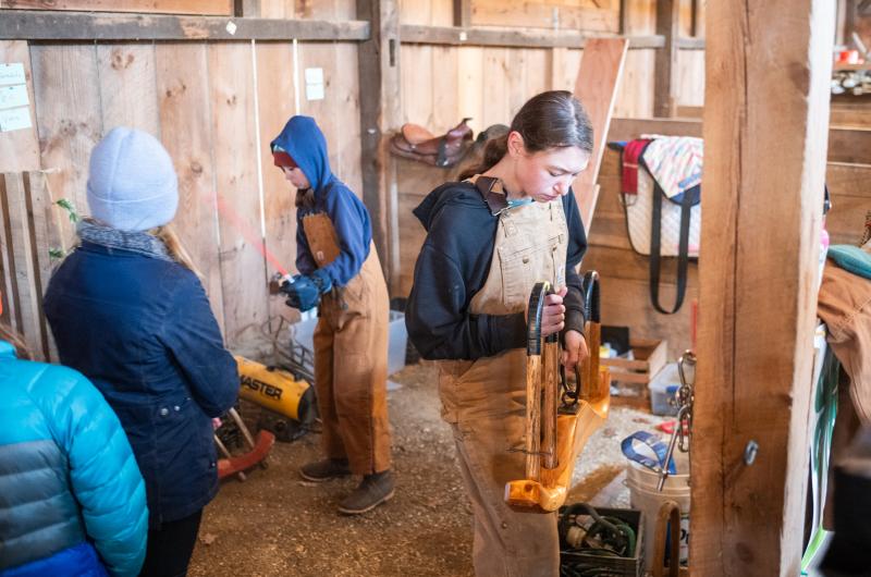 Wrenn Robertson grabbing a yoke from the barn.