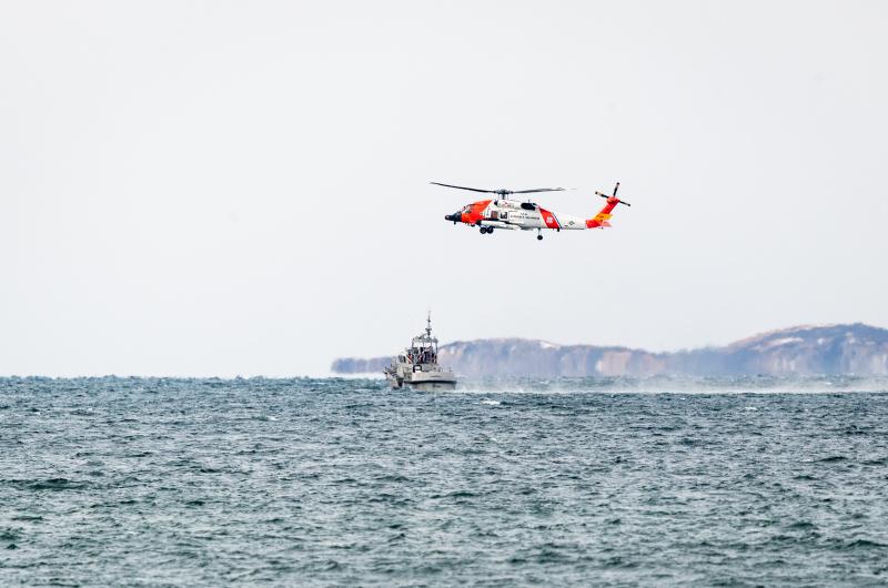 Helicopter makes multiple approaches toward Coast Guard cutter.